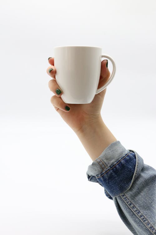 Person Holding White Ceramic Mug