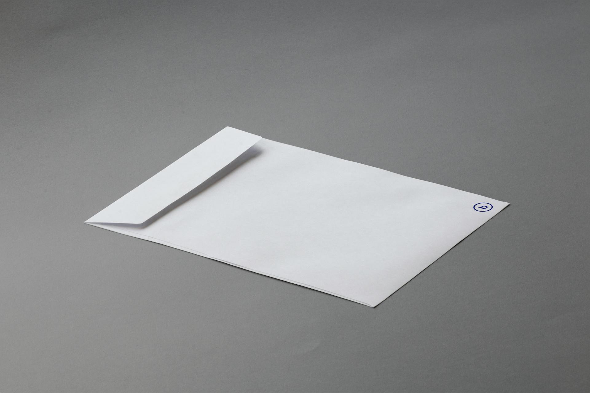 Simple white envelope on a gray background offering ample copy space.