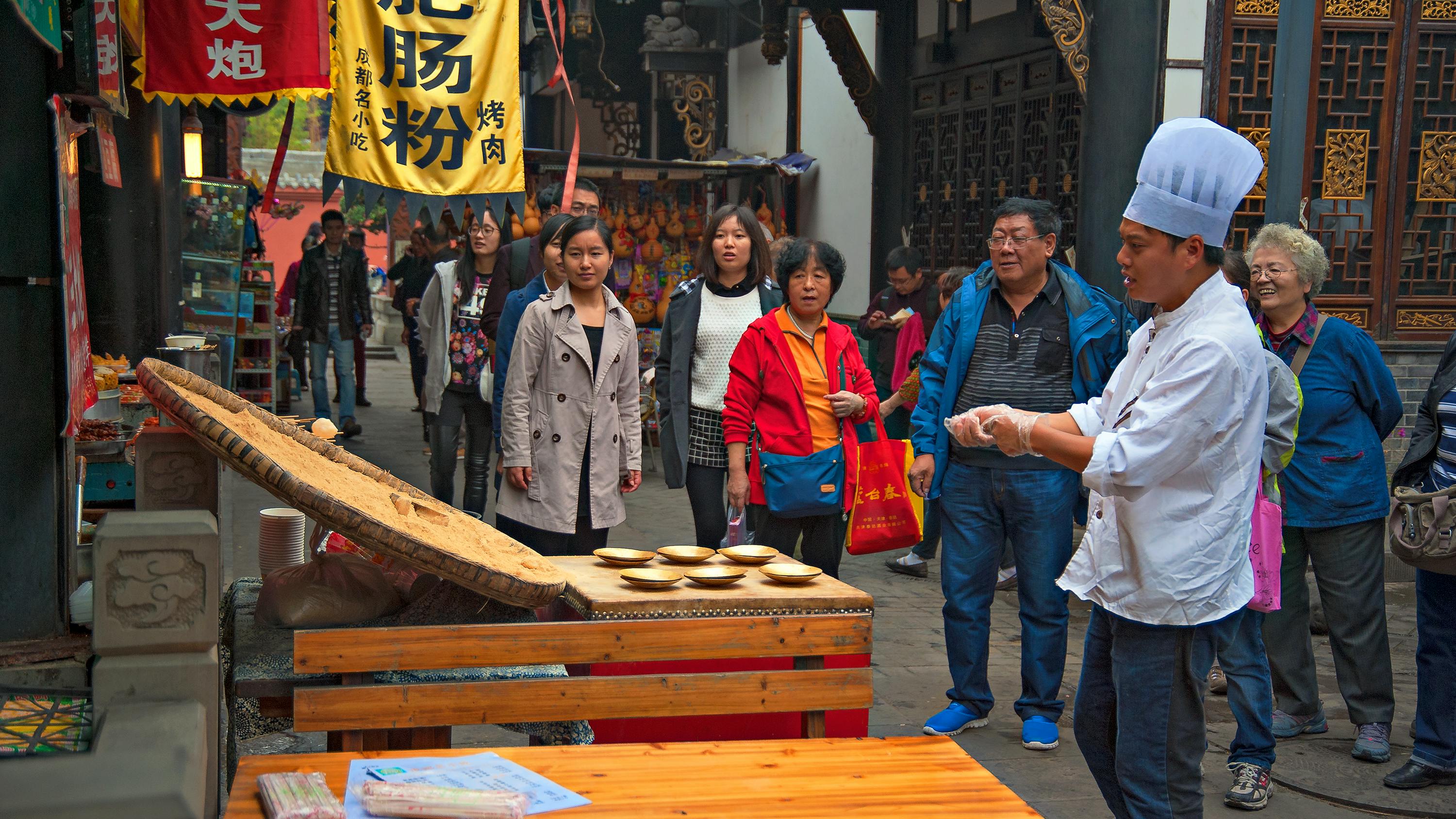 A collage of images from past Secret Ingredient Showdown events, showcasing the food, chefs, and audience