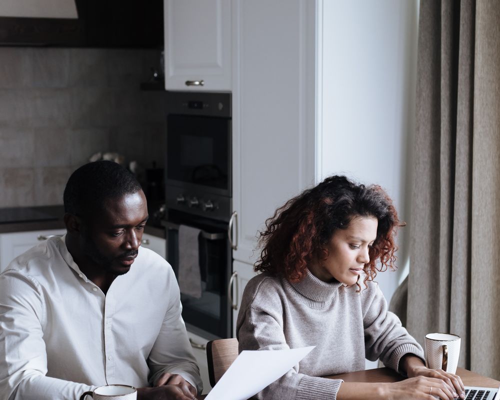 A couple reviewing paperwork together at home