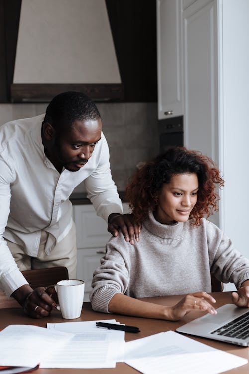 A Couple Looking at a Laptop At Home 