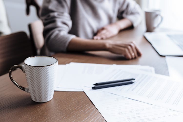 Mug And Papers On Table