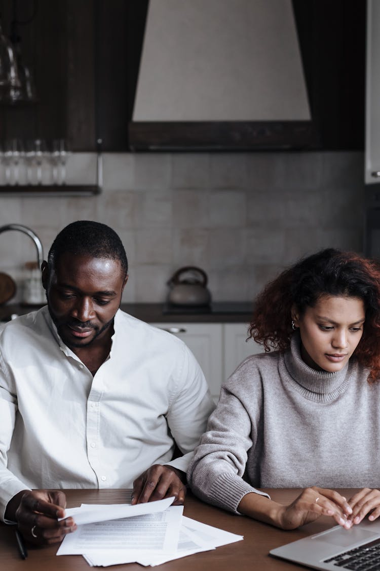 A Couple Working Together While At Home