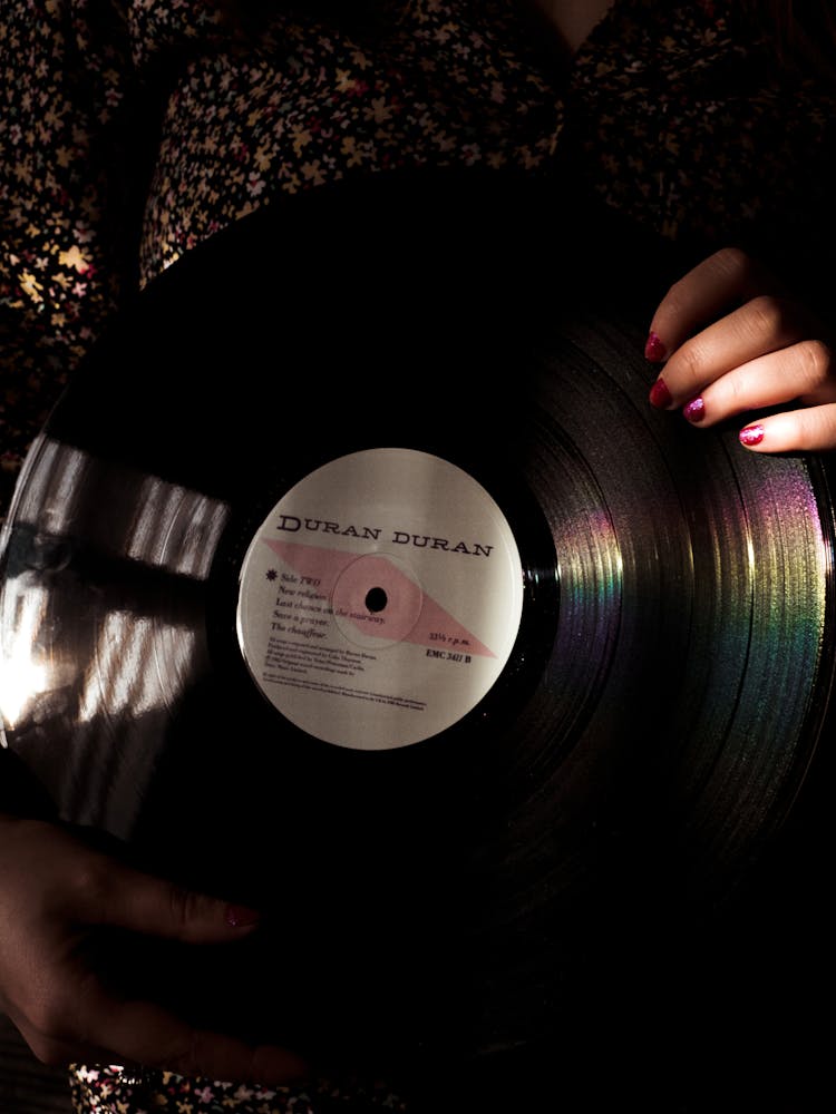 Hand With Painted Nails Holding Vintage Vinyl Record