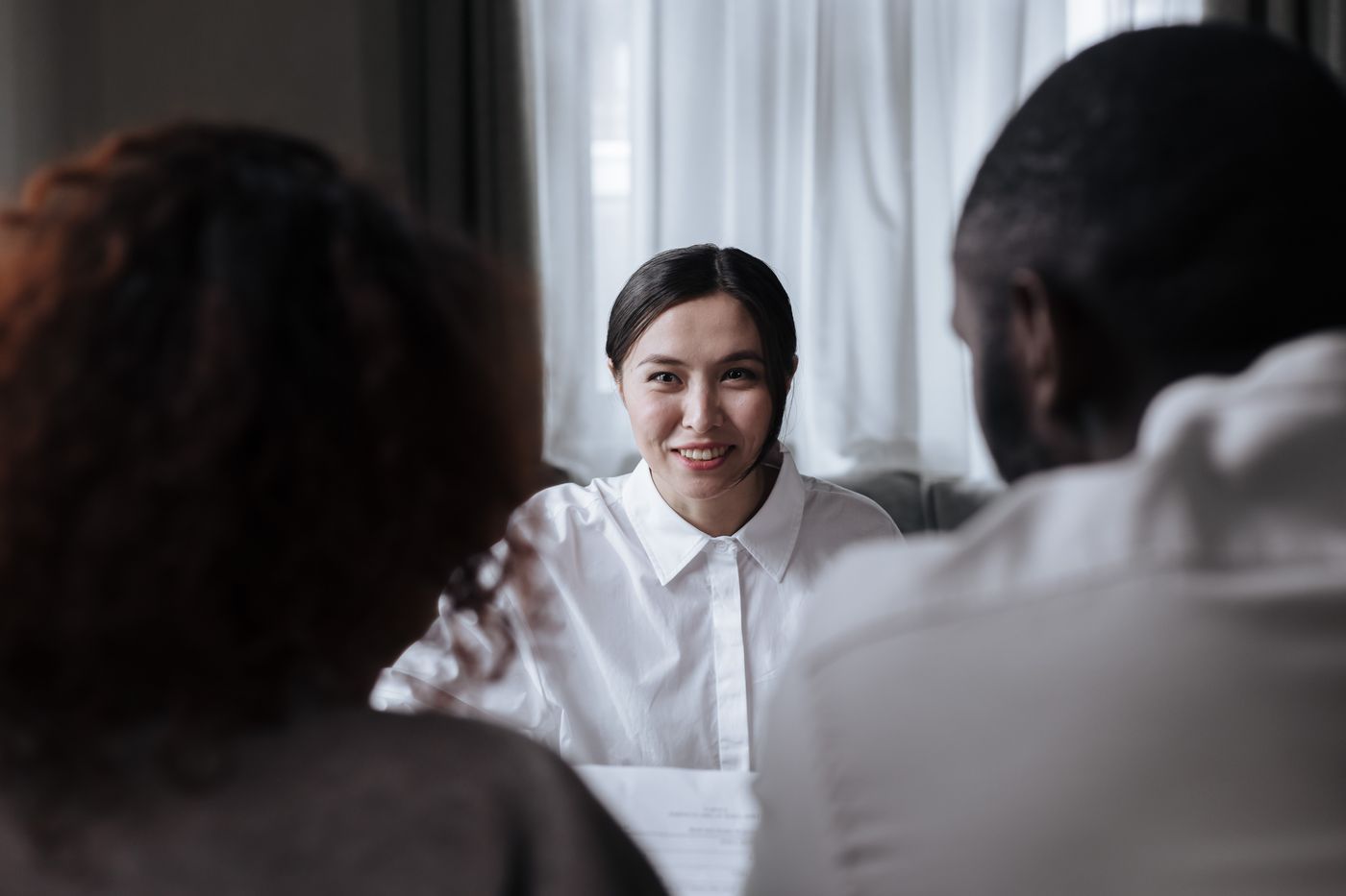 Welcoming professional speaking with a parent in a calm meeting setting