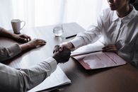 Unrecognizable Man Shaking Hands with Female Social Worker