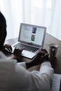 Unrecognizable Couple at Home Reviewing Adoption Form on Laptop Screen 