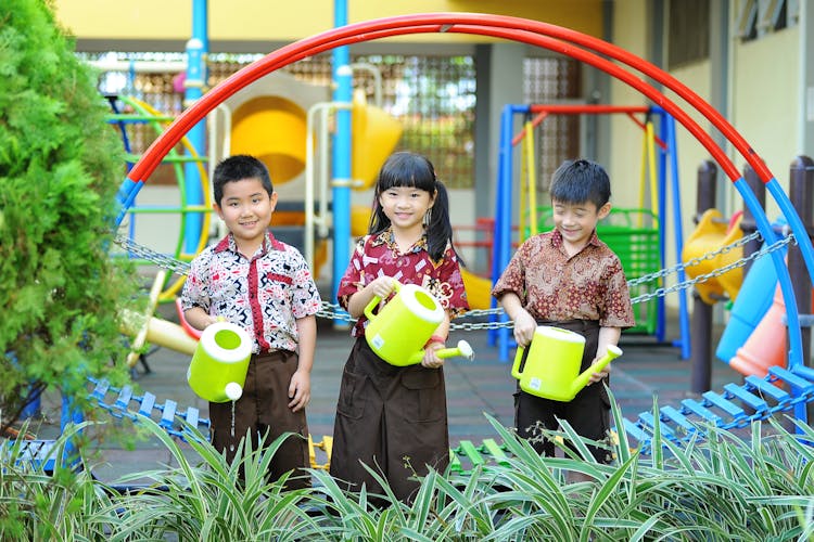 Kids Carrying Watering Cans