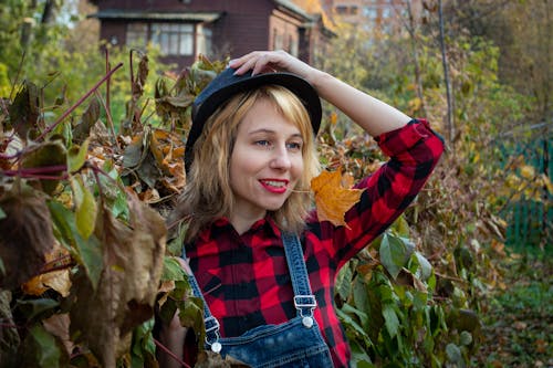 Woman Biting a Yellow Leaf