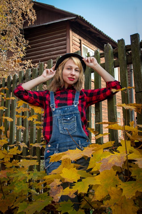 Woman Posing in front of a Wooden Fence