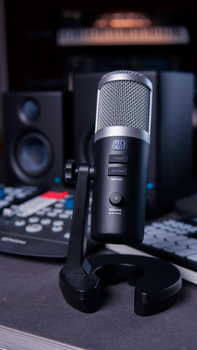 A sleek black microphone in a modern music studio, perfect for podcasts and recording.