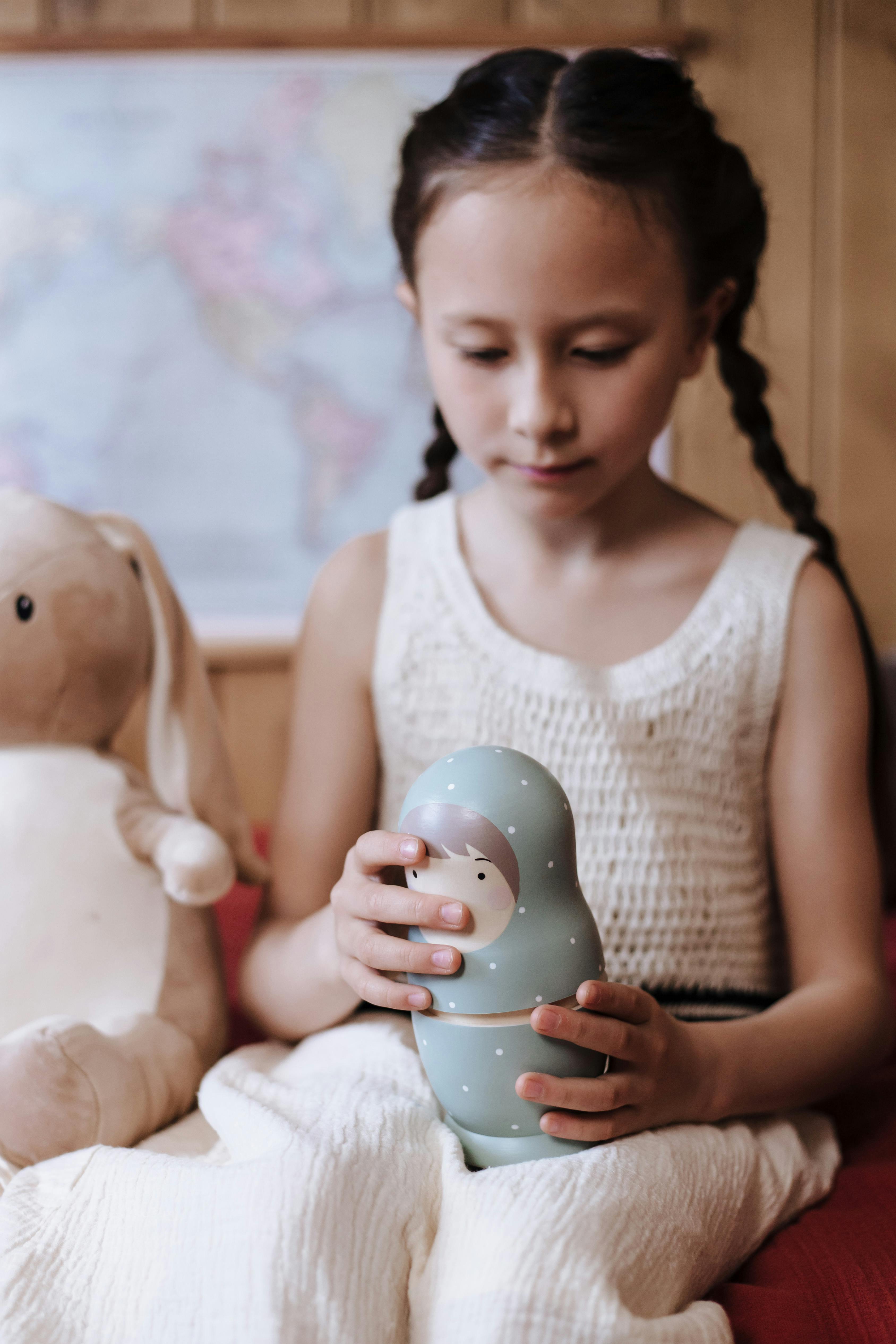 a little girl playing with matreshka