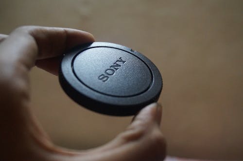 Free Person Holding Sony Camera Lens Cover Stock Photo