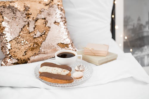 French Macarons and Eclairs on a Glass Plate