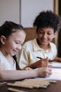 Brother and Sister Smiling While Drawing