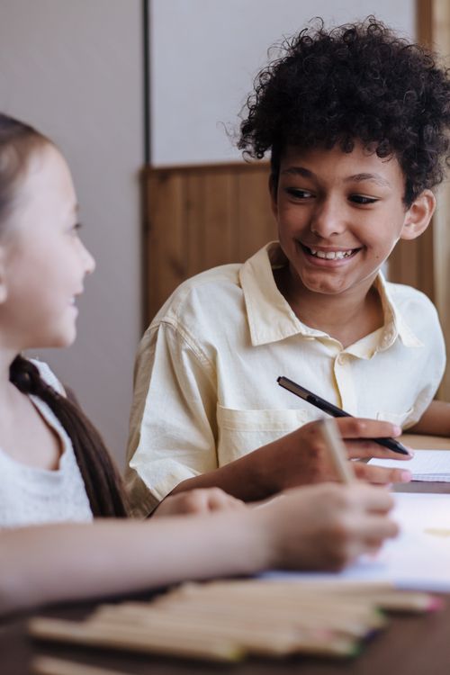 Free Two siblings happily engaged in drawing at home, sharing a moment of joy. Stock Photo