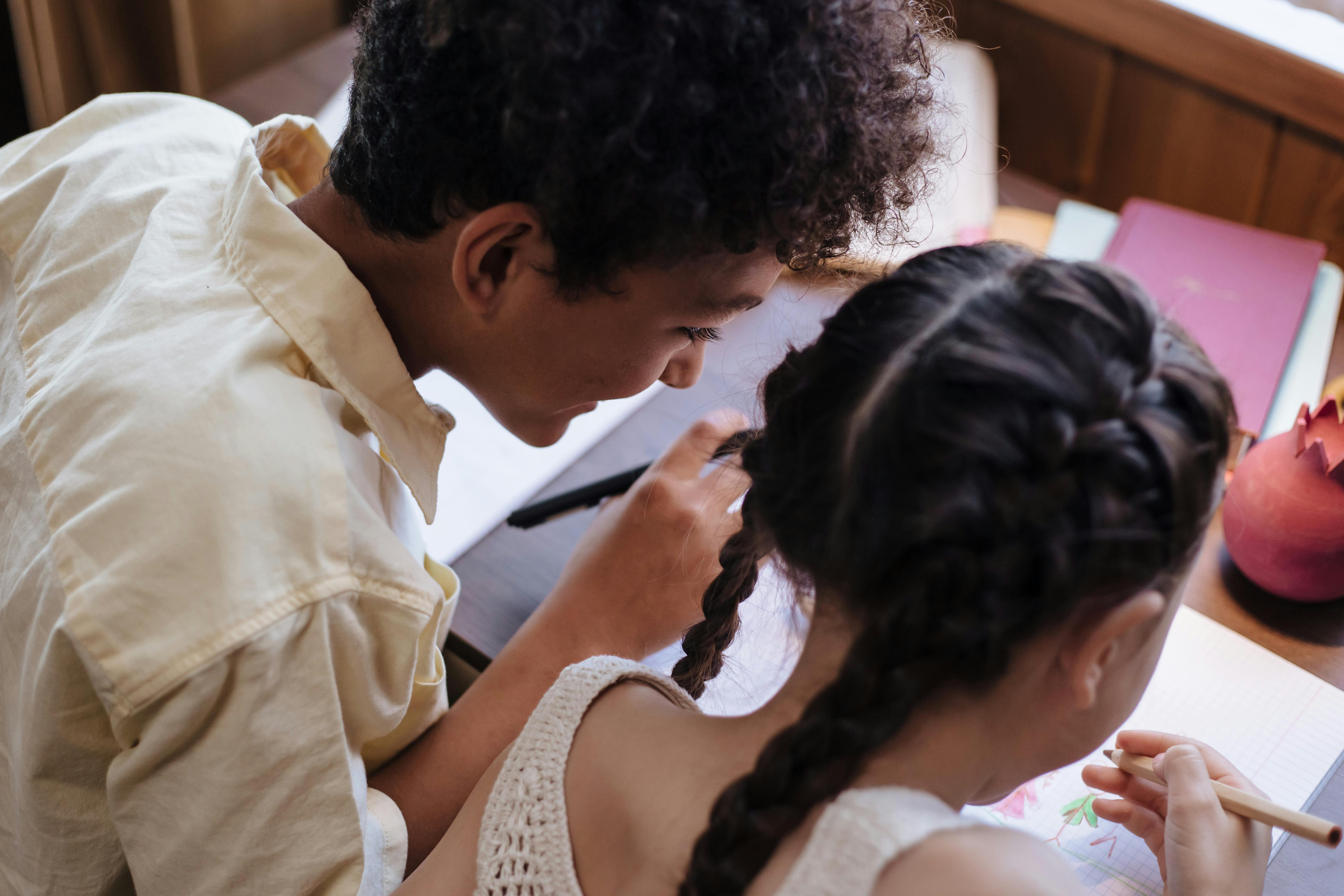 a brother and sister learning and drawing