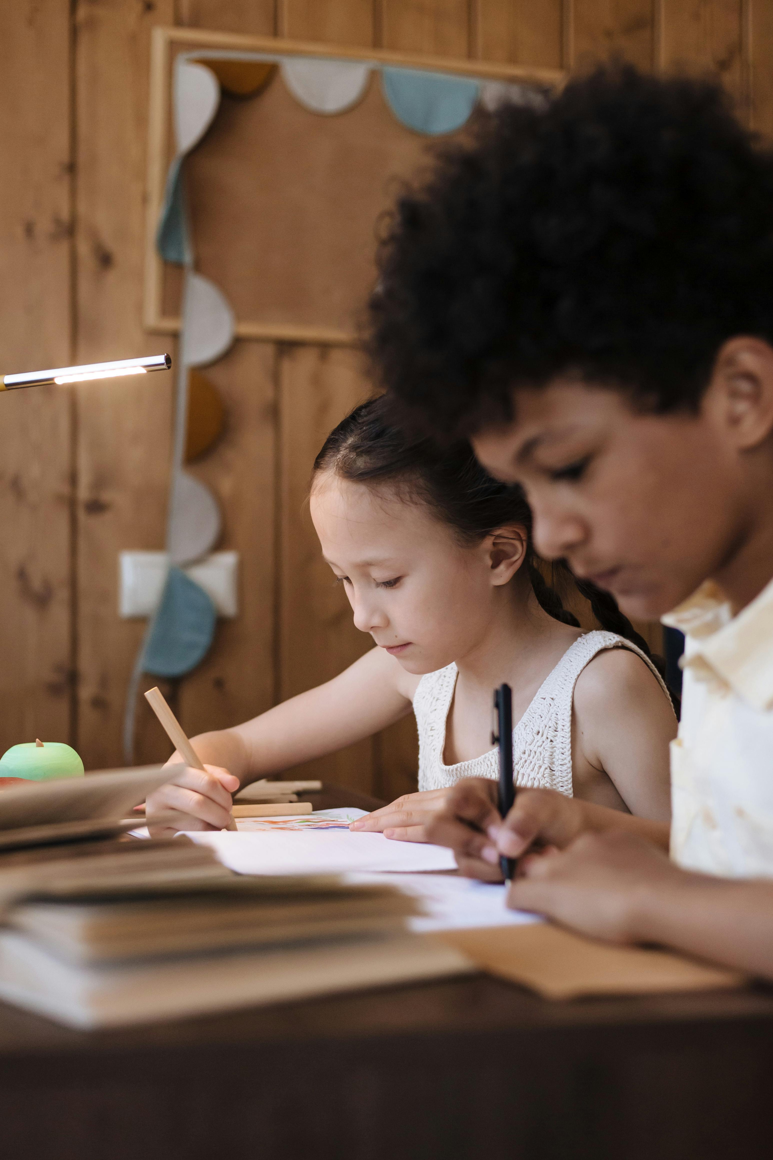 brother and sister learning handwriritng