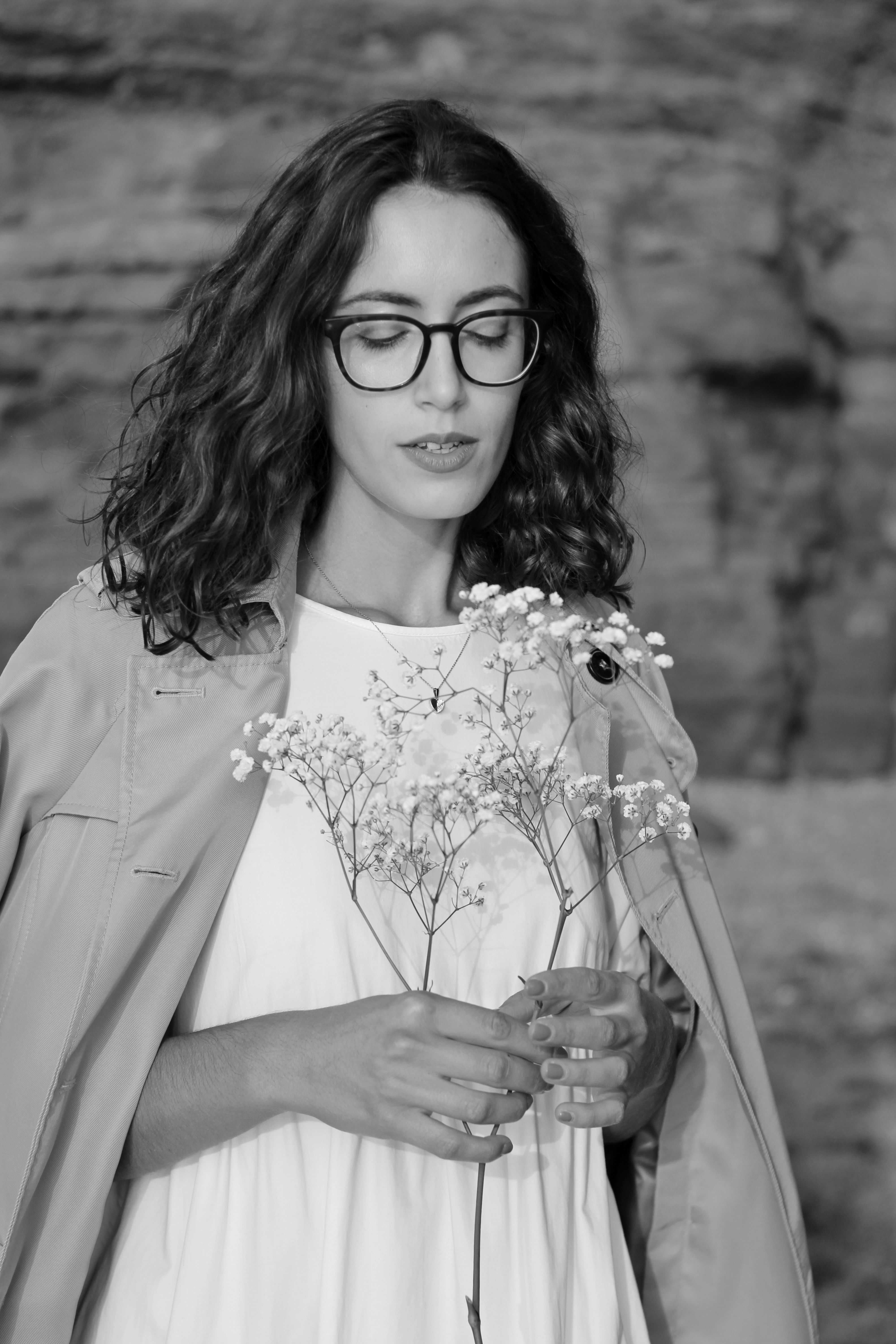 Black And White Portrait of Woman Holding Flowers · Free Stock Photo