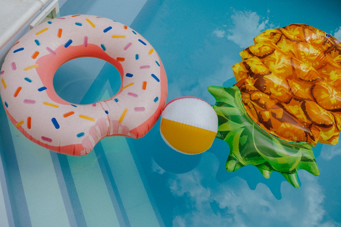 Inflatable Floaters in a Swimming Pool · Free Stock Photo