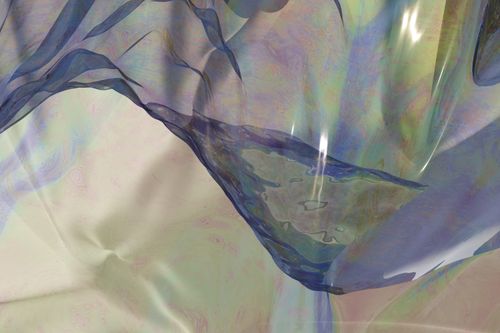 Pale iridescent film folding over itself, photo by Steve A Johnson on Pexels
