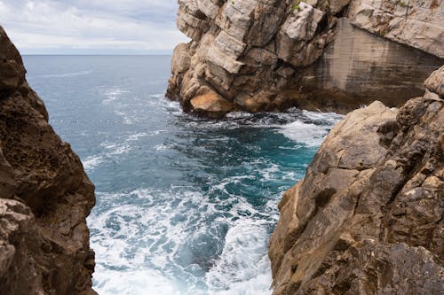 Free Waves Crashing on Rocky Coast Stock Photo