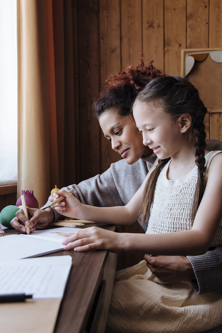 Girl Drawing With Mother