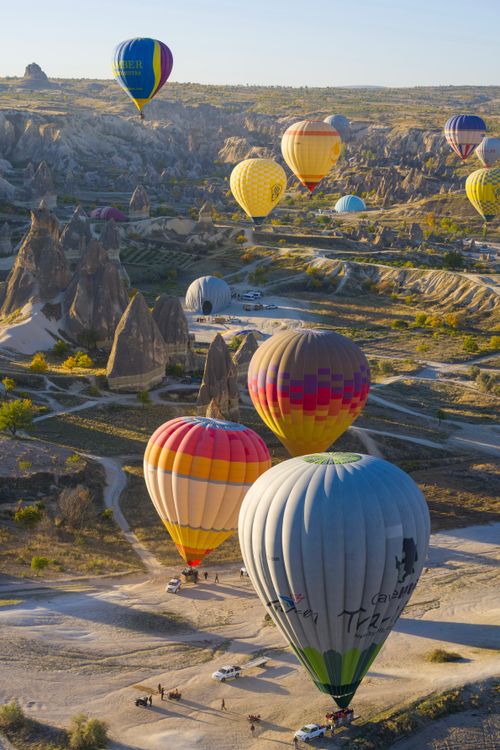 Free Stunning view of hot air balloons flying over Cappadocia's unique landscapes, showcasing a thrilling adventure. Stock Photo