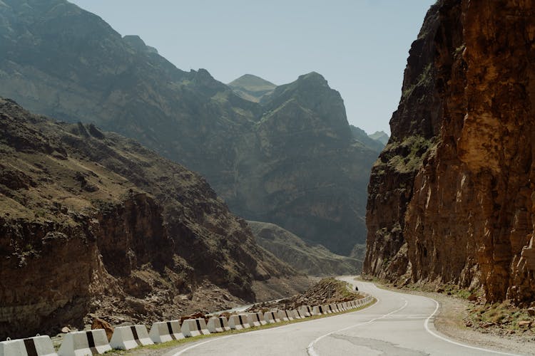 Empty Road Beside Rocky Mountains