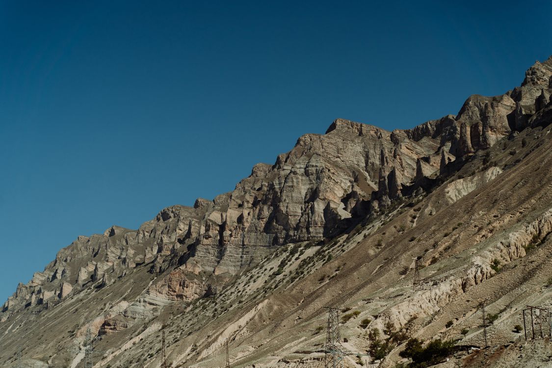 Mountainside Rocks Rocky Mountainside under Clear Blue Sky · Free Stock Photo