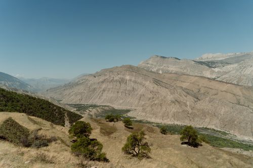 Free Expansive view of arid mountains under a clear blue sky. Stock Photo