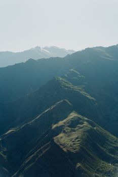 Serene aerial shot capturing the lush, fog-covered mountain landscape.
