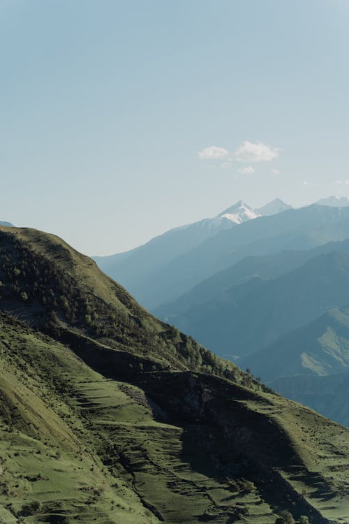 Free stock photo of blue sky, geological formations, green mountains