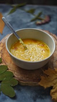 Warm bowl of soup topped with cheese, perfect for a cozy fall meal.