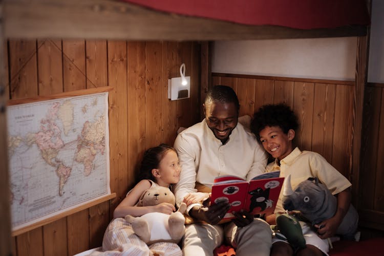 Father Reading Book To Kids