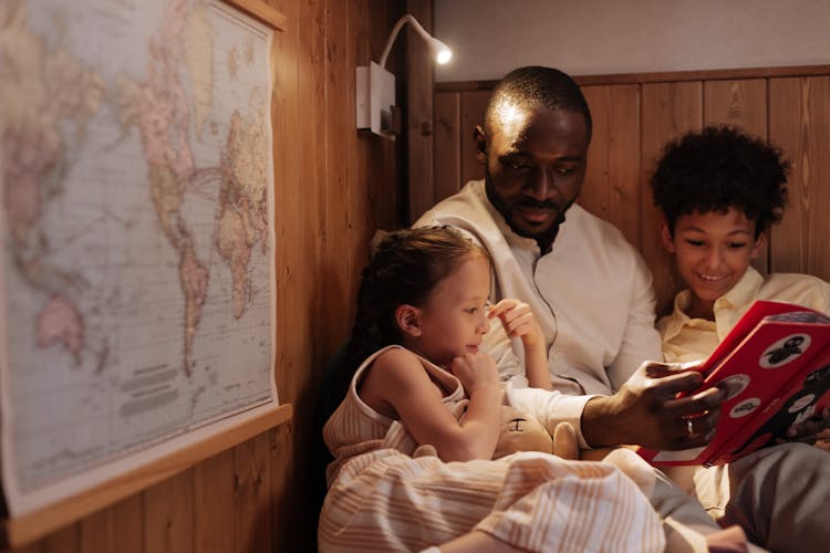 Father Reading Book To His Children