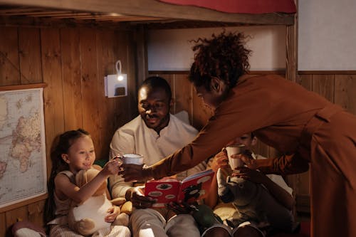 Free Mother Bringing Drinks to Her Children Stock Photo