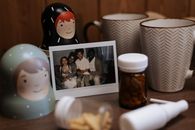 Family Photo on Table with Pill Bottle