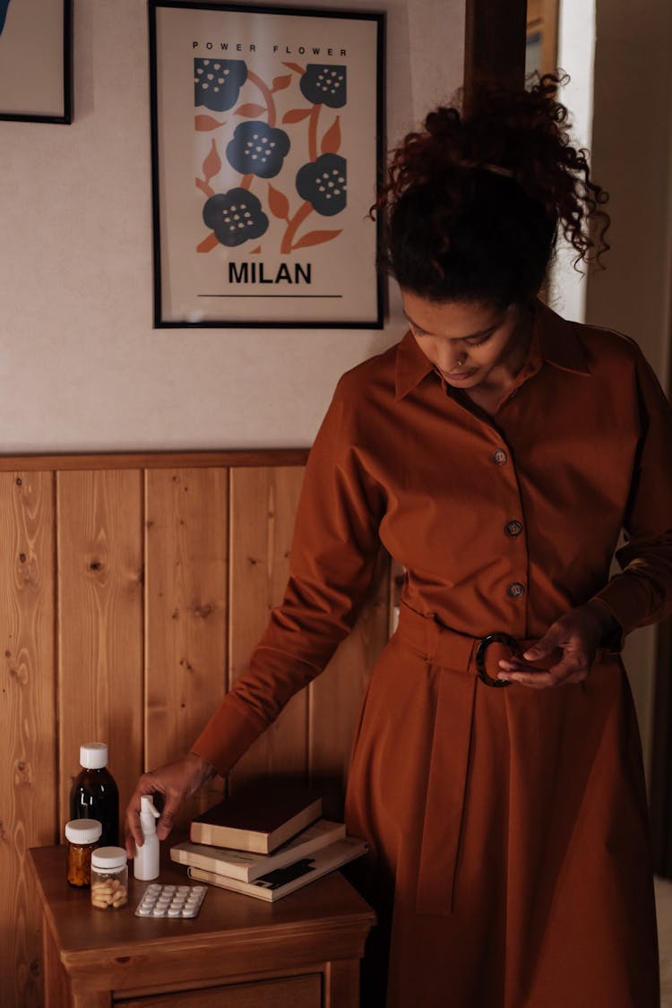 Mother Taking Throat Spray From Bedside Cabinet