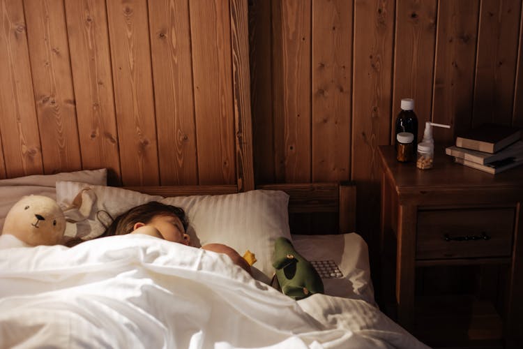 Girl Sleeping Well In Bed With Her Toys After Treatment