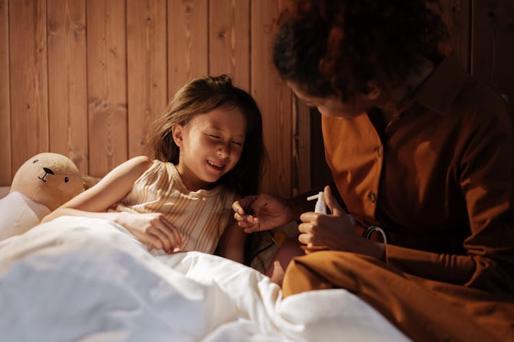 Mother Caring For Her Sick Daughter 