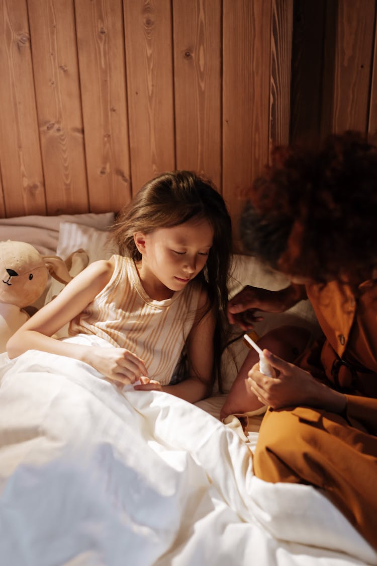 Mother Taking Care Of Sick Daughter 