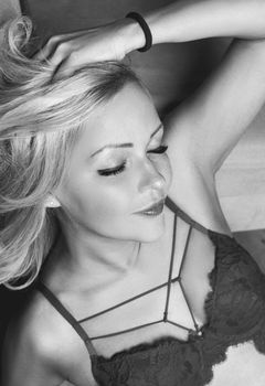 Monochrome portrait showcasing a woman in seductive lingerie with a serene expression.