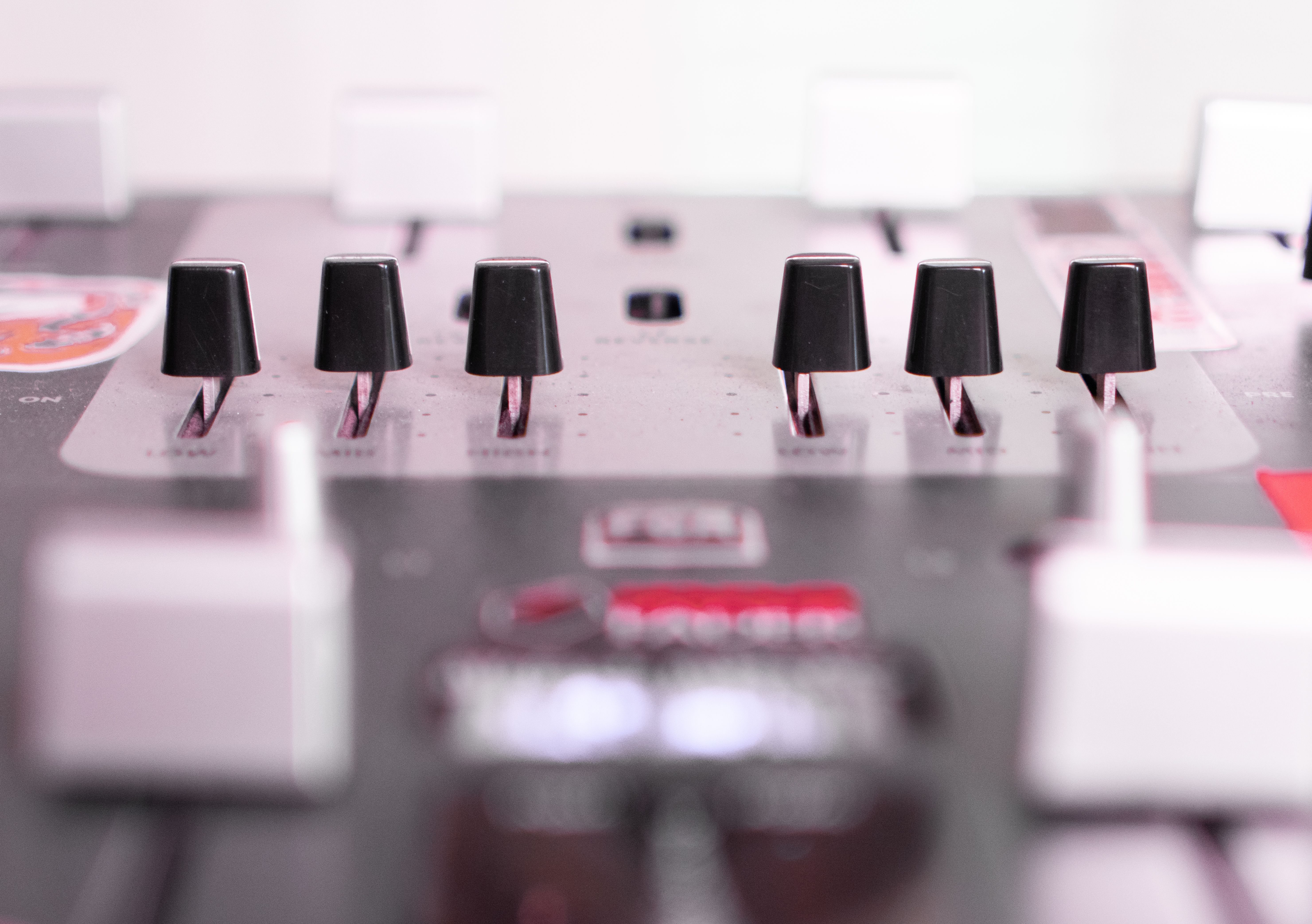 Detailed close-up of an audio mixer showing sliders and controls.
