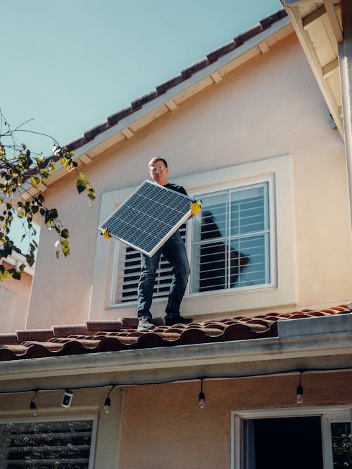 A Man Holding a Solar Panel