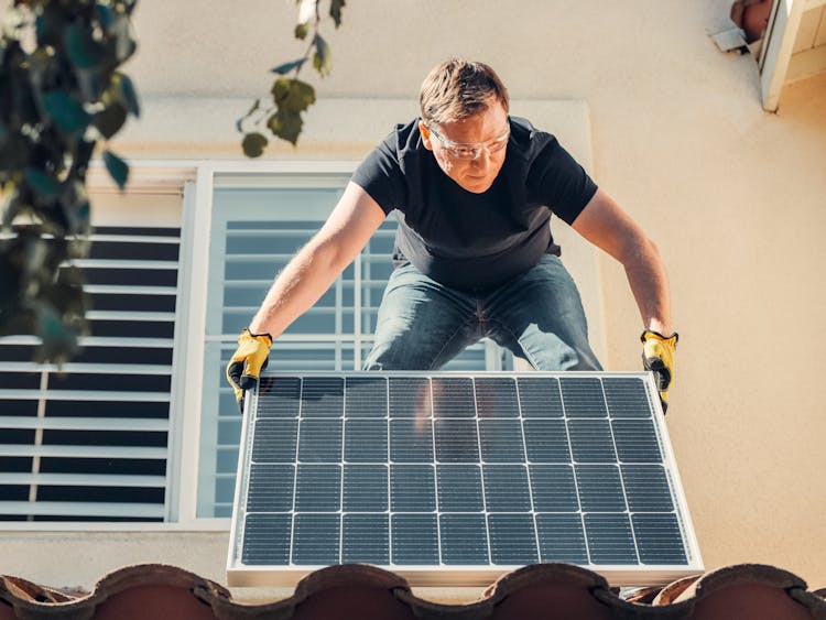 A Man Installing Solar Panel