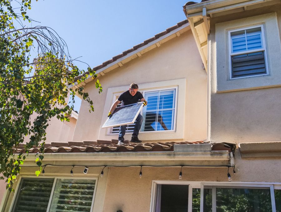 Homeowner watching panels go up on their roof
