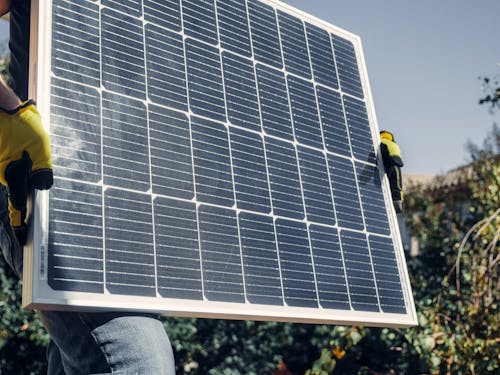 Free Person Holding a Solar Panel Stock Photo