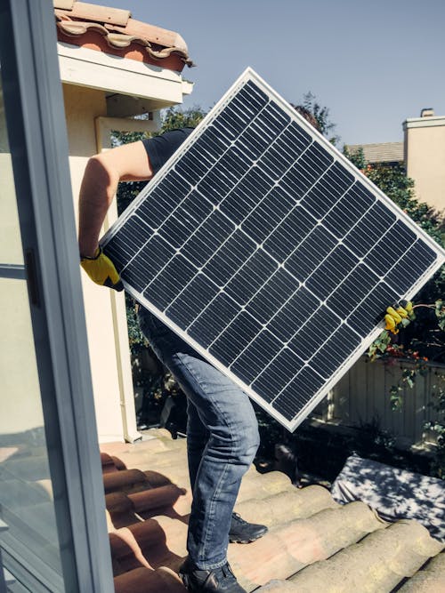 A Person Carrying a Solar Panel