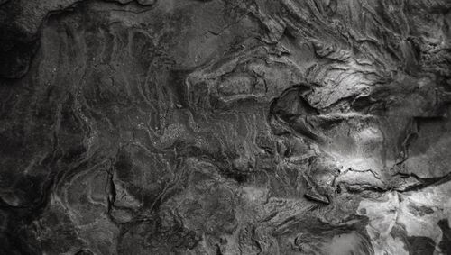 Free Close-up of detailed stone texture captured in grayscale, revealing natural patterns and rough surfaces. Stock Photo